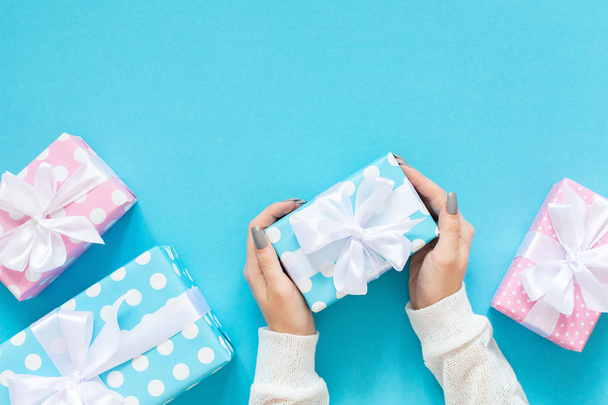 Background with female hands holding a gift box - Photo, Image