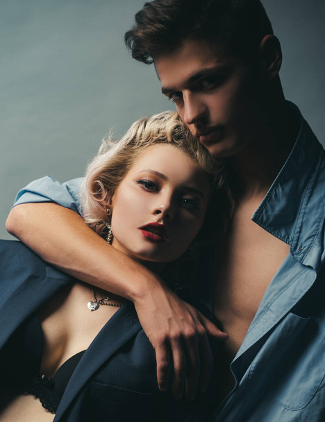 Handsome guy is hugging pretty girl with blonde hair. I Love You. Passion sex. Husband and wife get sexual pleasure from hugging. Muscular man. Pose for family portrait. - Фото, зображення