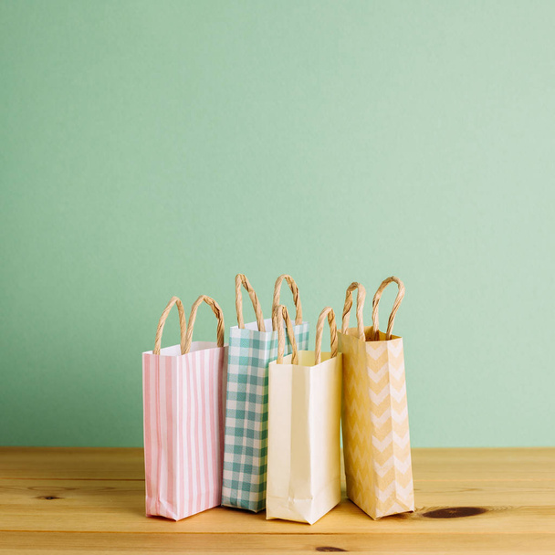 Bolsas de compras de papel colorido en mesa de madera
 - Foto, imagen