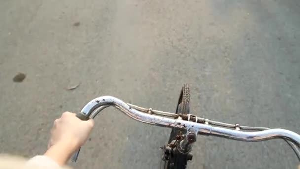 Riding bicycle on the street view from biker, Hand hold bicycle handle to keep balance. Learn to ride bike. - Footage, Video