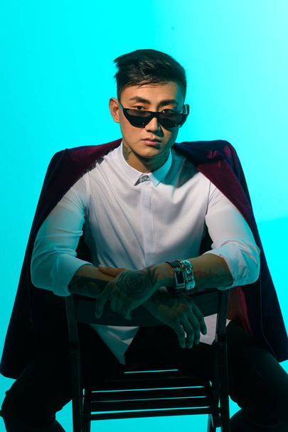 portrait of a fashionable asian man with glasses and a jacket - Foto, Bild