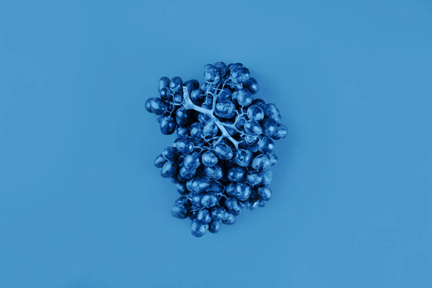 Classic blue color of 2020. Grapes flat lay - Photo, Image