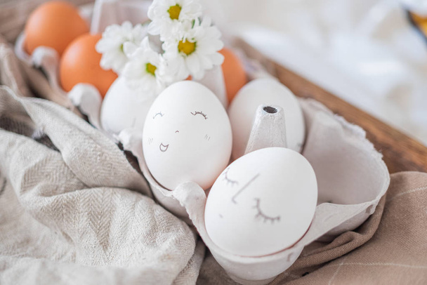 monochrome easter eggs with faces top view. Easter holiday concept. Rustic easter design - 写真・画像