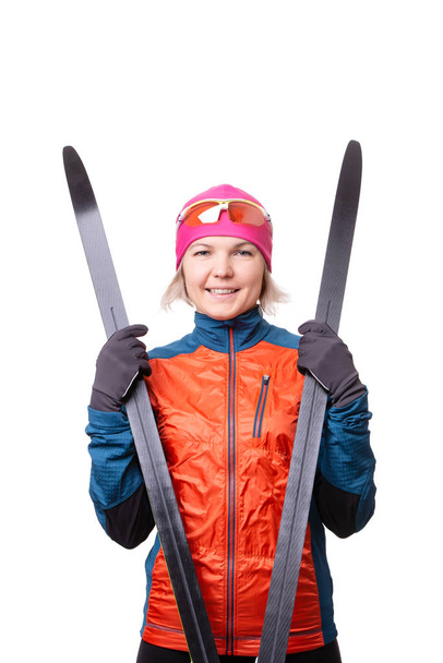 Image of smiling sportswoman with skis on empty white background. - Photo, Image