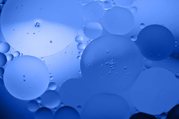 Defocused abstract background picture made with oil, water and soap. Blue toned. - Фото, зображення