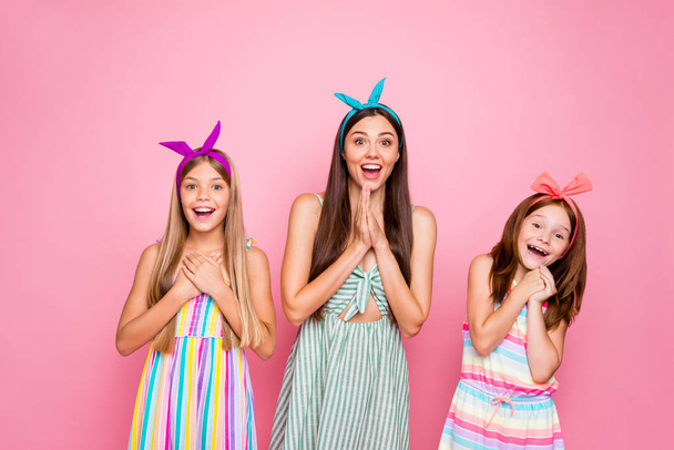 Portrait of cheerful people with headbands screaming wow omg hearing news wearing colorful dress skirt isolated over pink background - Фото, зображення