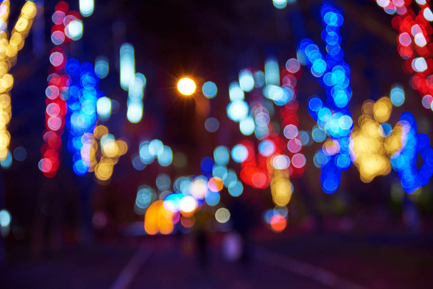 Blurry street lights and festive garlands on the street at night - Photo, Image