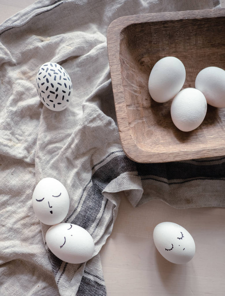 monochrome easter eggs with faces top view. Easter holiday concept  - 写真・画像