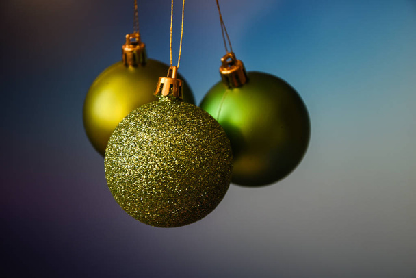 Green and gold Christmas ornament balls  over blue purple pantone Holiday Background, Copy Space, place for text  - Фото, зображення