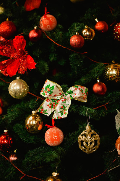 Christmas background, blurred background with Christmas tree and toys. Decorated Christmas tree on  blurred, sparkling and fairy background. Christmas tree background - Photo, Image