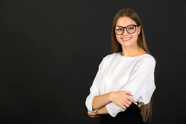 beautiful young woman in glasses on a black background - Fotografie, Obrázek