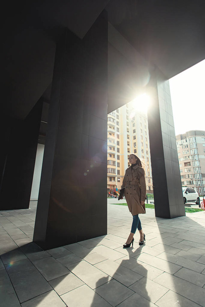 Self-confidence young business woman with file in a hand. outdoor. cityscape - Фото, зображення