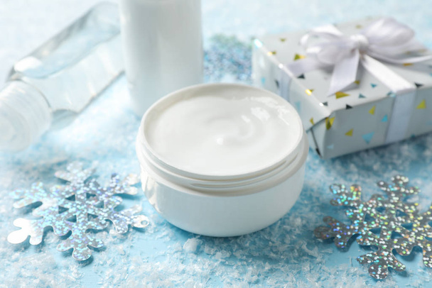 Set cosmetic, winter cream for skin on snowy blue background, sp - Photo, Image