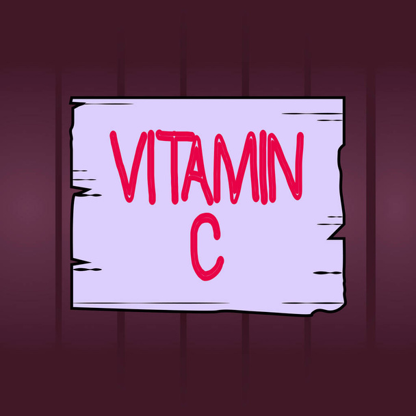 Writing note showing Vitamin C. Business photo showcasing it promotes healing and helps the body absorb iron Ascorbic acid Wooden plank slots grooves wood panel colored board lumber. - 写真・画像