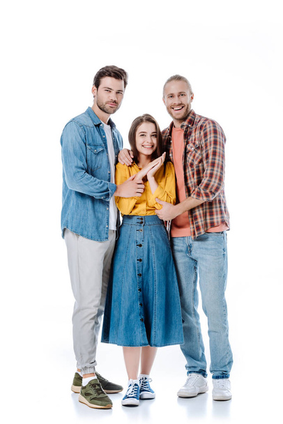 full length view of happy three young friends hugging isolated on white - Φωτογραφία, εικόνα