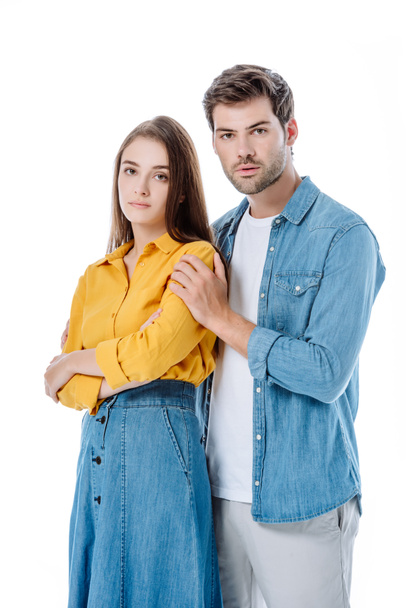 sad young couple in denim hugging isolated on white - 写真・画像