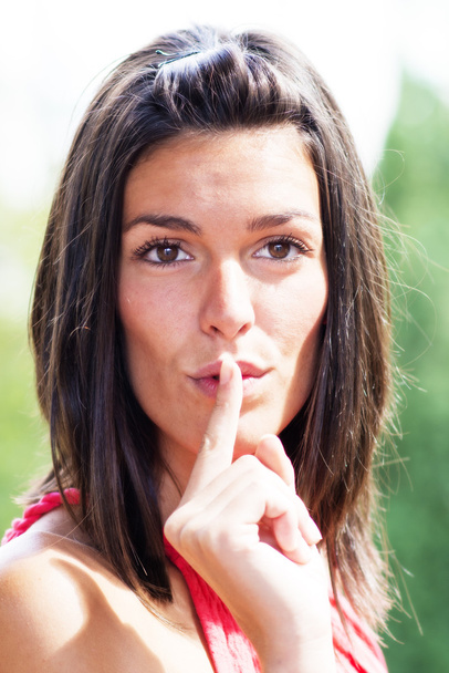 Portrait of mysterious woman making silence sign. - Foto, Imagen