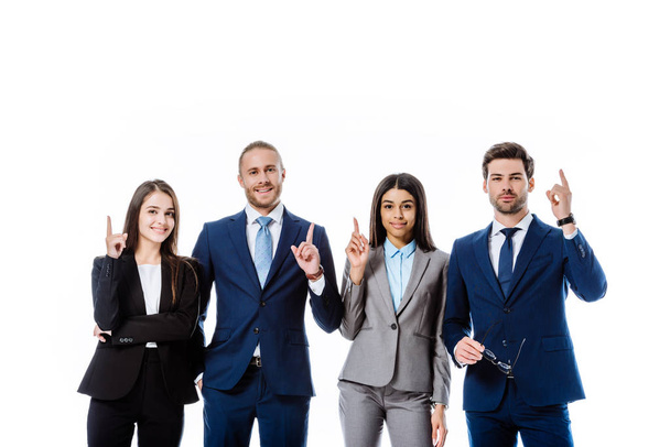 multicultural business people in suits pointing with fingers up isolated on white - Foto, afbeelding