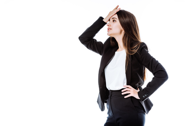 stressed businesswoman in suit with hand on hip touching head isolated on white - Φωτογραφία, εικόνα