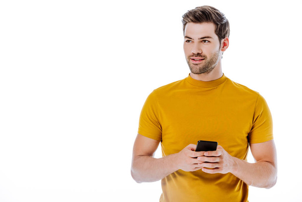 handsome man using smartphone and looking away isolated on white - Φωτογραφία, εικόνα