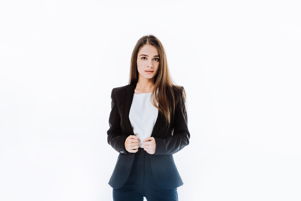 confident businesswoman in suit with hands on jacket isolated on white - Photo, Image