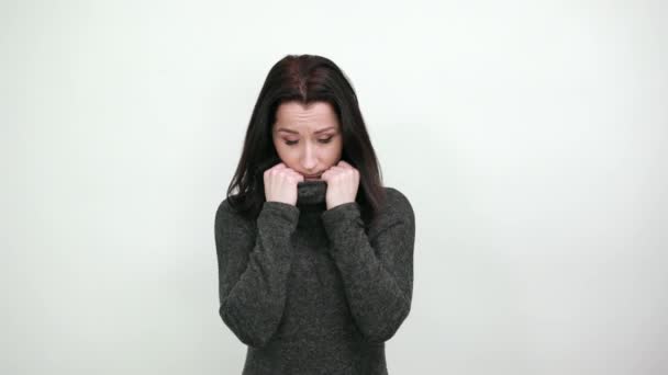 Scared young woman in biting nails, looking frightened. Lifestyle concept - Footage, Video
