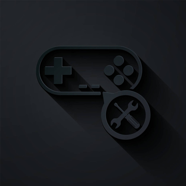 Paper cut Gamepad with screwdriver and wrench icon isolated on black background. Adjusting, service, setting, maintenance, repair, fixing. Paper art style. Vector Illustration - Vector, Image