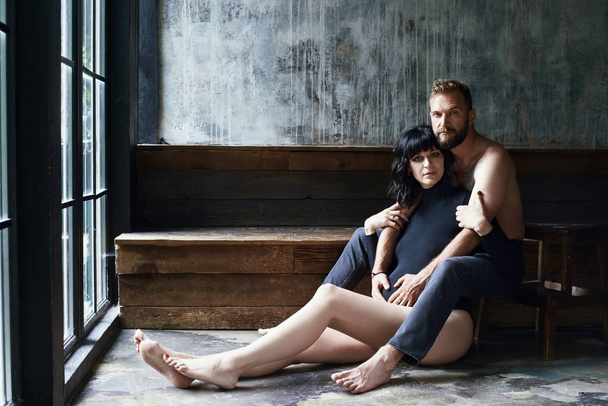 Beautiful couple awaiting for little baby in loft interior - 写真・画像