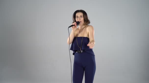 Girl singing into a microphone - Video, Çekim