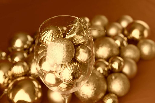 Glass with golden Christmas decorations - Photo, Image