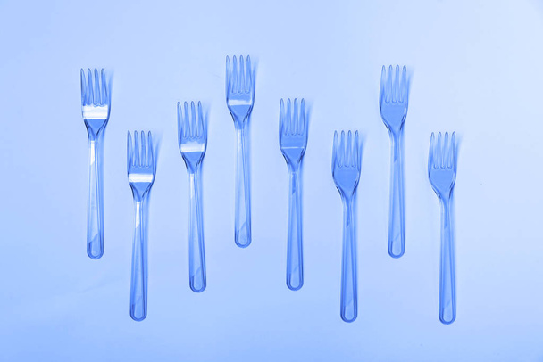 Plastic fork pattern on classic blue background. - Fotoğraf, Görsel