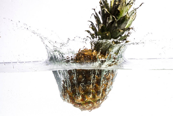 Fresh pineapple jumping into water. abstract, aqua, background, bubble - Photo, Image