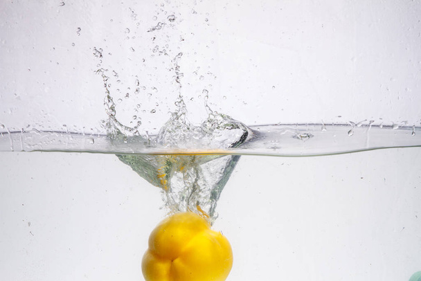 three peppers falling in water - Photo, Image