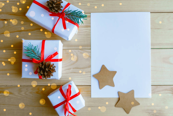 Рождественские подарочные коробки и белый макет холостой на деревянном фоне
 - Фото, изображение