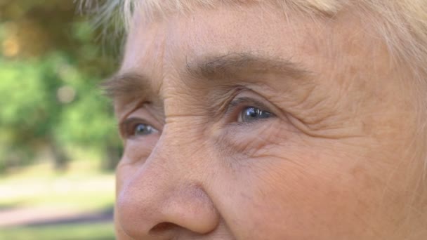 Female wrinkled face, lonely pensioner outdoors, old age problem, sad thoughts - Felvétel, videó