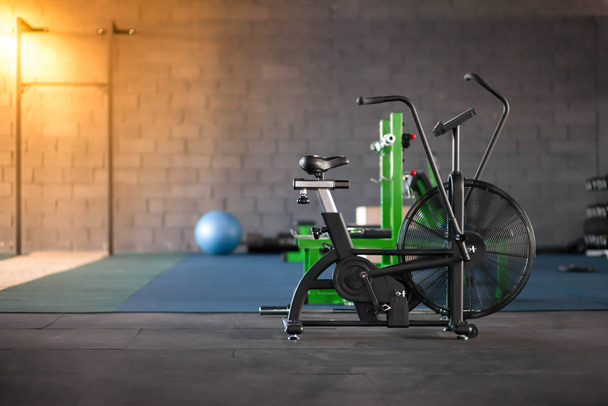 Sports equipment in the gym. Exercise bike at the sport club. Healthy lifestyle concept - Photo, Image