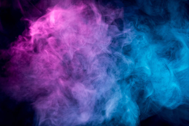 . Transparent creativity. Abstract art colored smoke on black isolated background. Stop the movement of multicolored smoke on dark backgroun - Foto, afbeelding