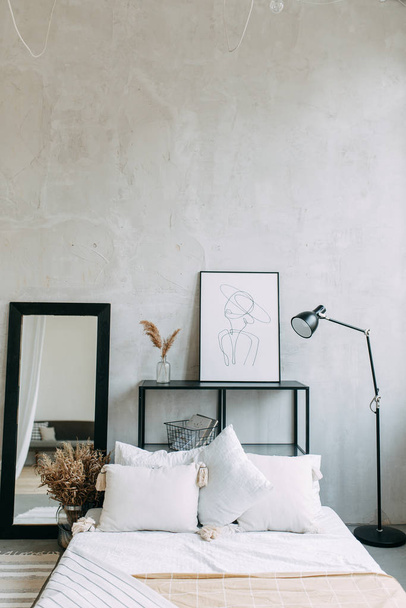 Bright photo Studio with a bed and a window. Stylish modern loft interior.  - Фото, изображение