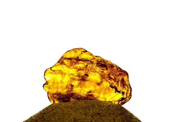 Amber in sun with inclusions on a white empty background - Photo, Image