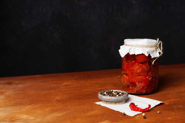 Dried tomatoes in a jar with spices. - Zdjęcie, obraz