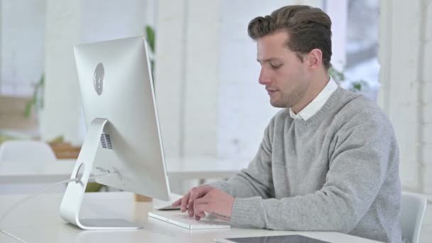 Young Man working on Desktop and doing Thumbs Down  - Кадри, відео