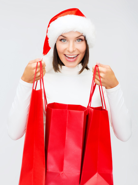 Woman in santa helper hat with shopping bags - Zdjęcie, obraz