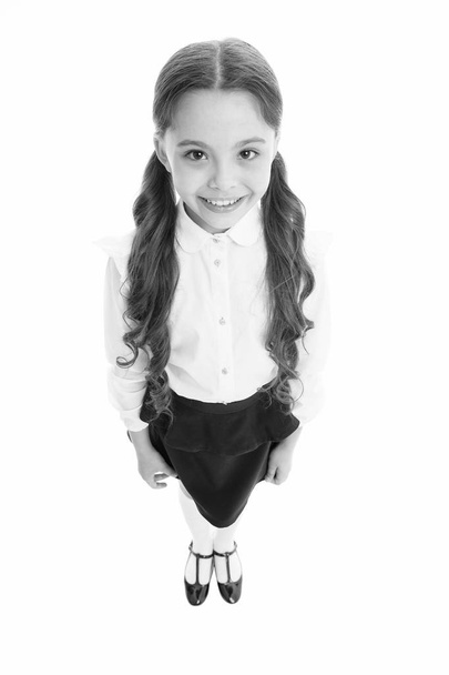 Cheerful smile. Girl cute pupil on white background. School uniform. Back to school. Student little kid adores school. Pupil of first grade. Celebrate knowledge day. September time to study - Fotó, kép