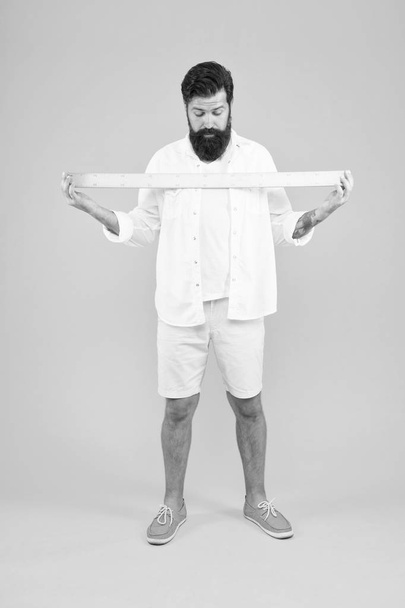 One meter. Big size. Measure. Geometry theorem. Actual size. School teacher. Small little big large. Does size really matter. Man bearded hipster holding ruler. Measure length. Size tall and length - Foto, imagen