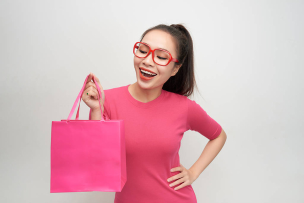 Joyful woman shopping packages pink color - Foto, imagen