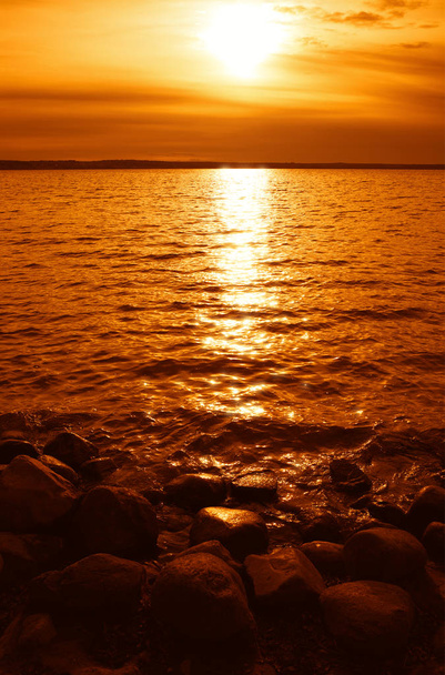 Burning sunset on rocky beach landscape background - Foto, immagini
