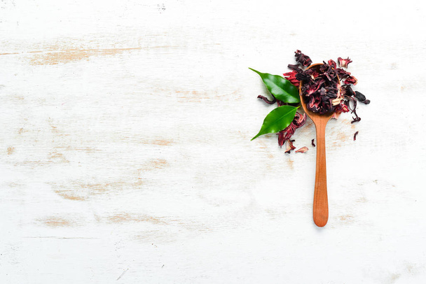 Red Hibiscus tea in Wooden spoon. On a rustic background. Top view. free space for your text. - Fotografie, Obrázek