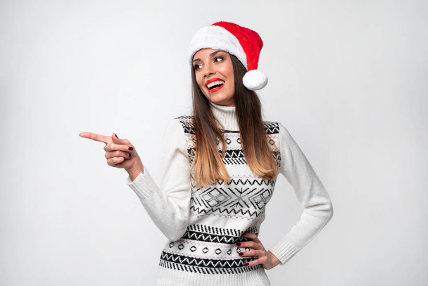Close up portrait beautifiul caucasian woman in red Santa hat on white studio background. Christmas and New Year holiday concept. - Φωτογραφία, εικόνα