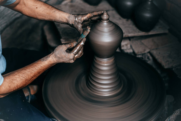 potter hands doing clay bowl on wheel - 写真・画像
