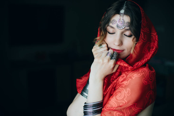 Oriental portrait tribal style of beautiful woman wearing jewellery and   red palatine  - Fotografie, Obrázek